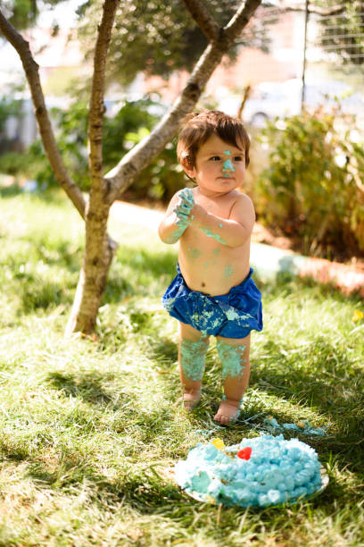 istock Baby playing with a cake during cake smash birthday party 863209750