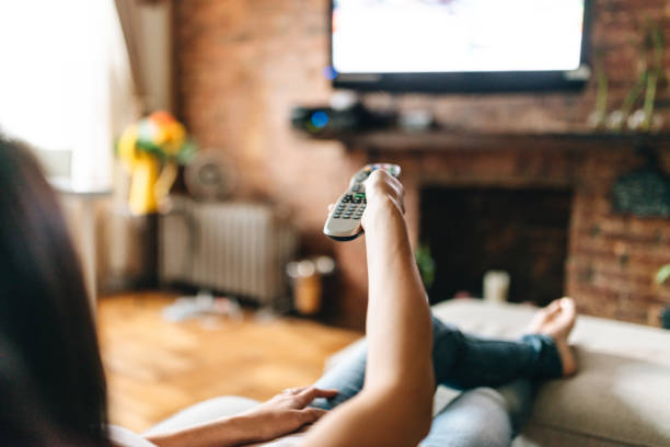 istock woman looking the tv at home 863240148