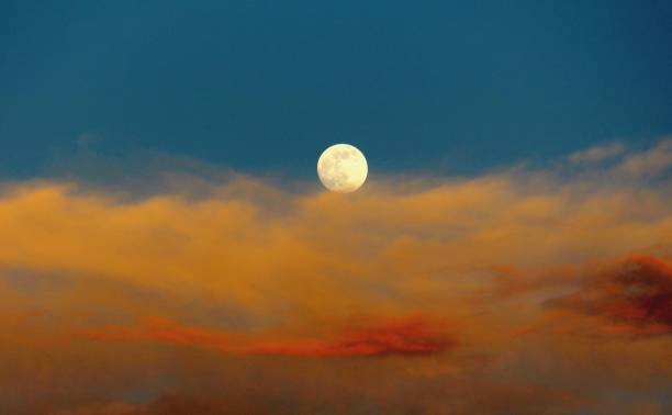 istock Moonrise Over Fiery Sunset Couds 863254374