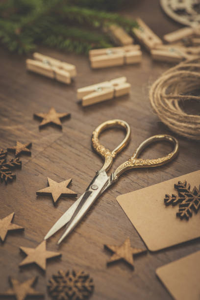istock Christmas. Vintage style scissors and gift boxes on a rustic wooden table 863259556