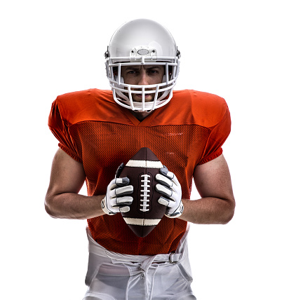American football player teenager on black background.