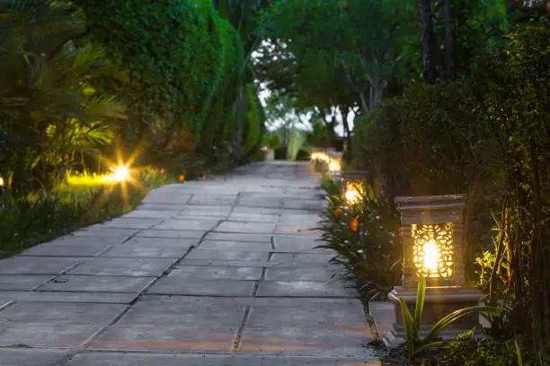 Photo of ceramic ware lamp street in the garden walkway at twilight