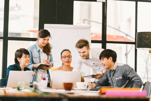 istock Multiethnic team busy discussion using laptop, digital tablet. Coworker partnership, college student meeting. Small business casual office, freelance designer job, or online marketing analysis concept 863291810