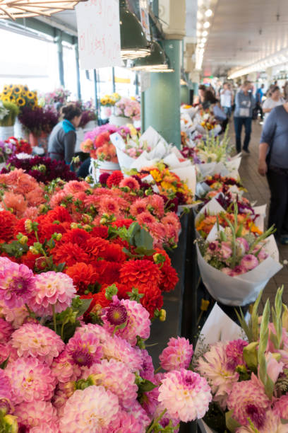 Seattle, United States August 6, 2013 A woman purchases flowers at Pike Place Market.