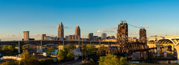 Cleveland panorama Panoramic view of Cleveland Ohio with bridges spanning the Cuyahoga, just before sunset cuyahoga river photos stock pictures, royalty-free photos & images