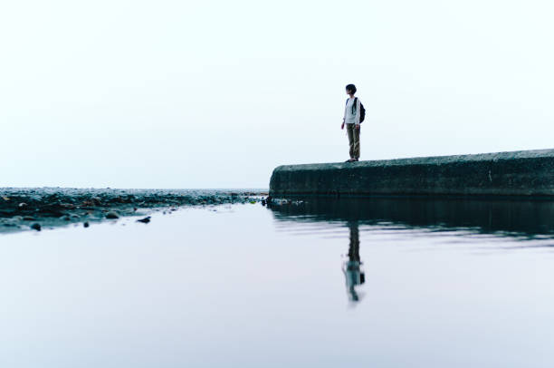 istock Woman Standing by Ocean 863306480