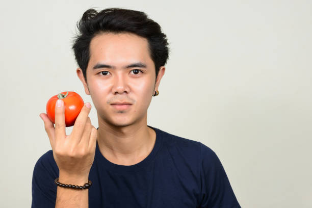 istock Young Asian man wearing blue shirt against white background 863306782