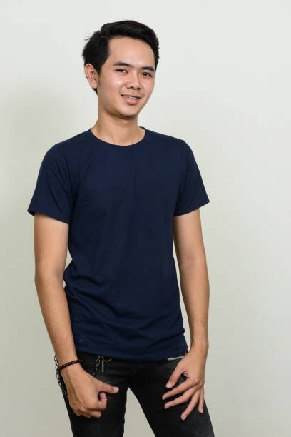 istock Young Asian man wearing blue shirt against white background 863312192