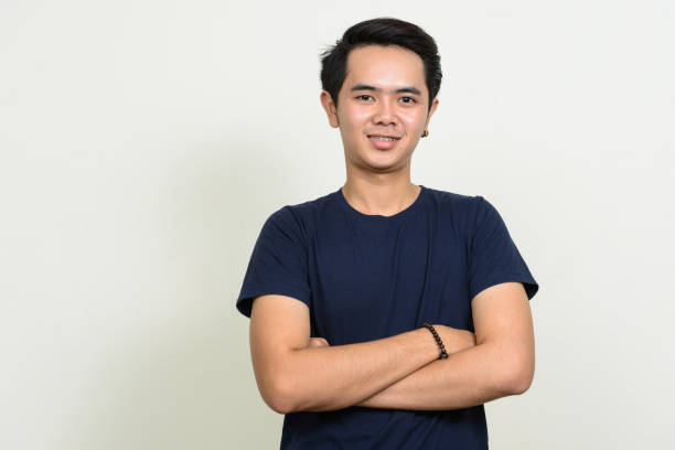 istock Young Asian man wearing blue shirt against white background 863312220