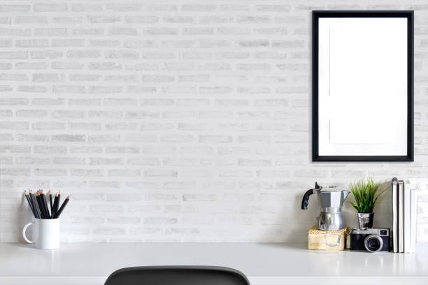 istock Loft workspace concept. Mock up white frame, vintage camera and stuff, minimal stuff on desk. 863315180
