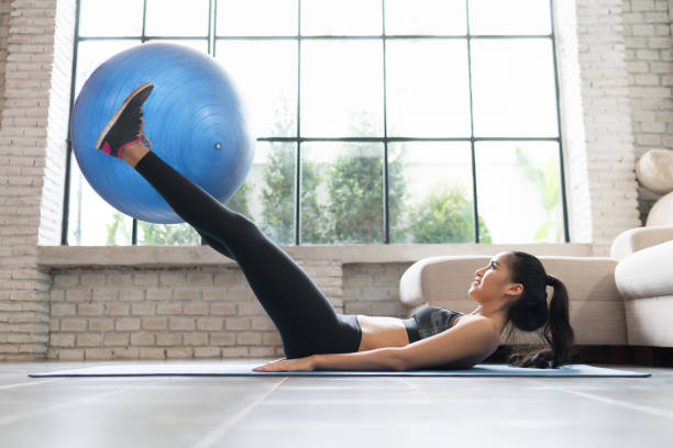 istock Asian women using an exercise ball in her house. 863317466