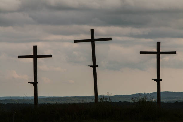 istock Three Wooden Crosses Stand Against A Dark Ominous Sky 863329294