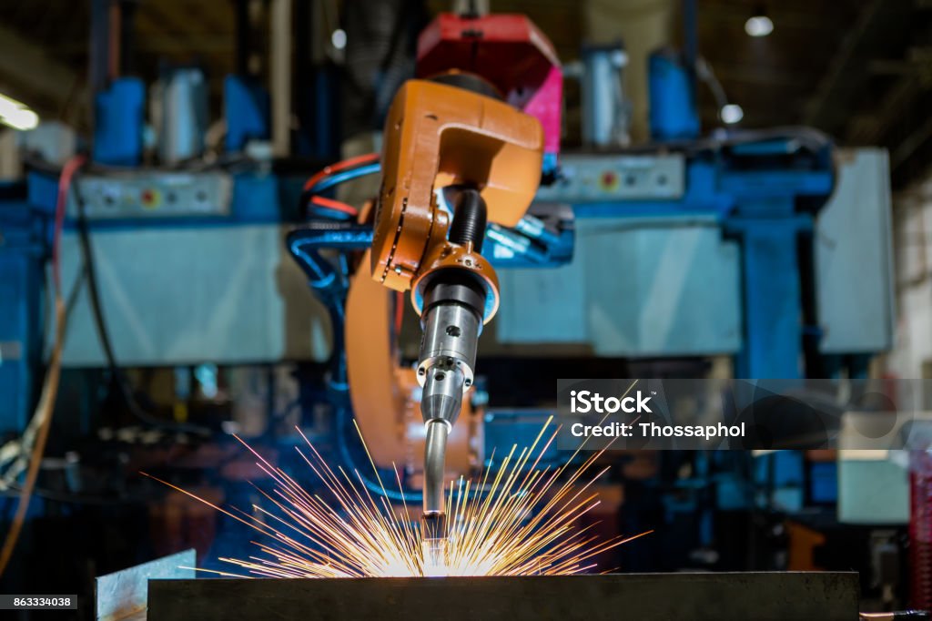 Robot is welding assembly automotive part in car factory Robot Stock Photo