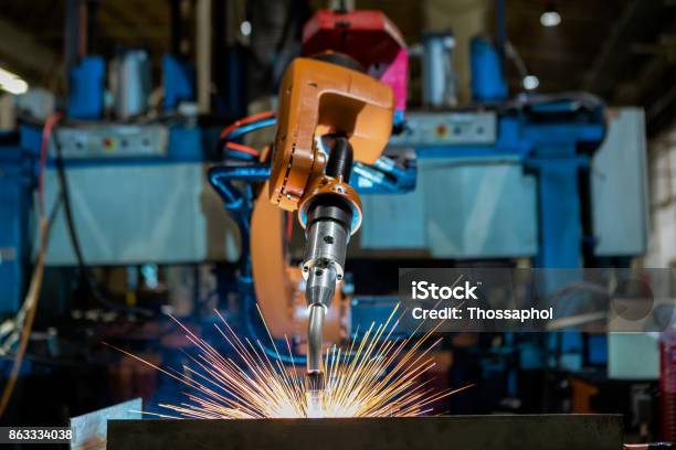 Robot Is Welding Assembly Automotive Part In Car Factory Stock Photo - Download Image Now