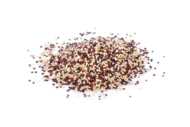 Photo of pile of dry tricolor quinoa seeds on white background