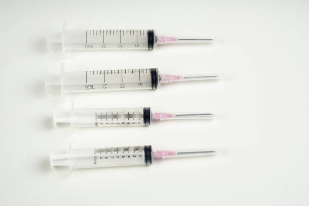 istock insulin and large syringe, white background. 863339490
