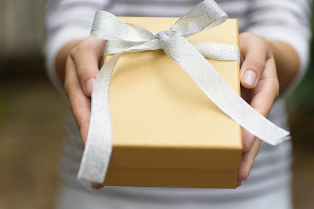 istock Golden gift box in hand for giving 863348220