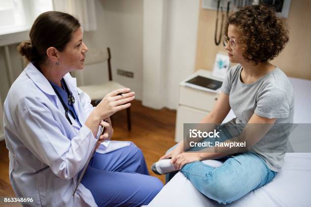 Doctor Is Checking A Patient Stock Photo - Download Image Now - Doctor, Teenager, Patient