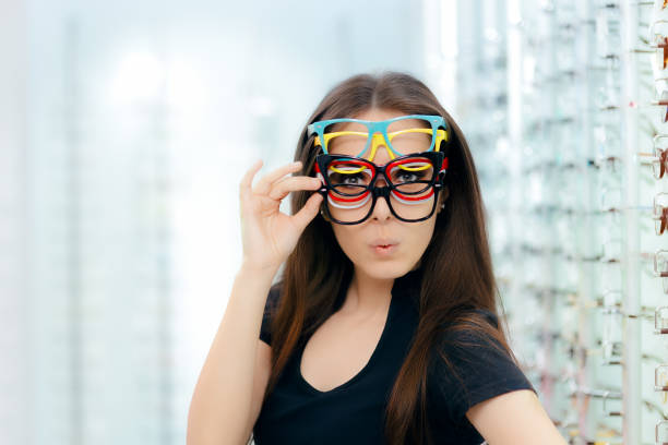 istock Funny Woman Trying Many Eyeglasses Frames in Optical Store 863371124