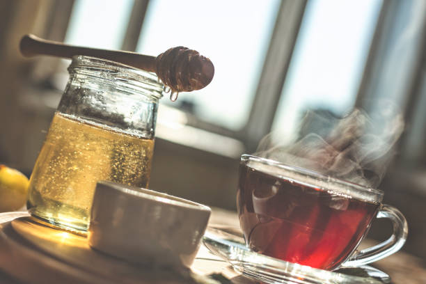 istock Natural bee honey with morning tea. Pouring honey. 863371378