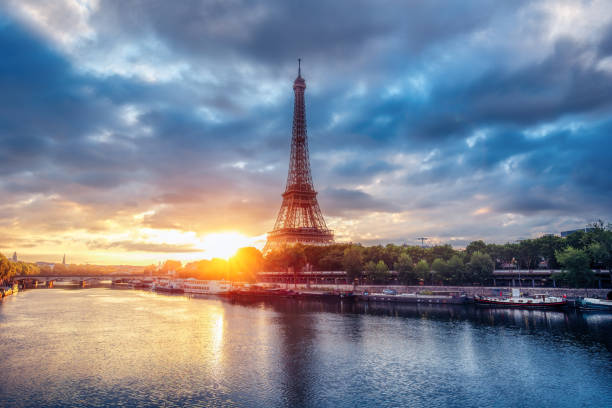 istock Amazing view over the Eiffel Tower from a bridge at sunrise with Seine river and bridge. 863380550