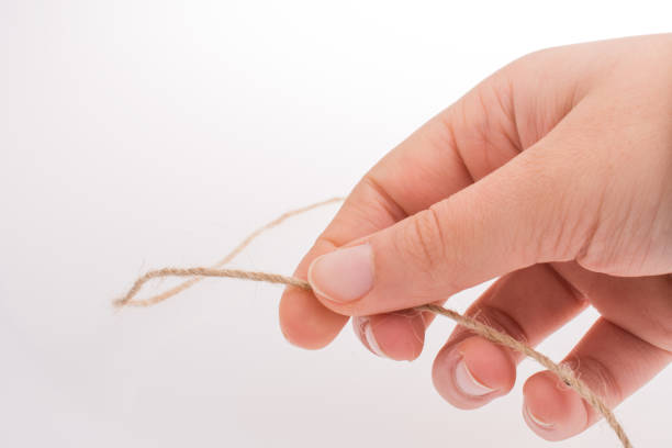 istock Hand holding brown color linen thread in hand 863396824