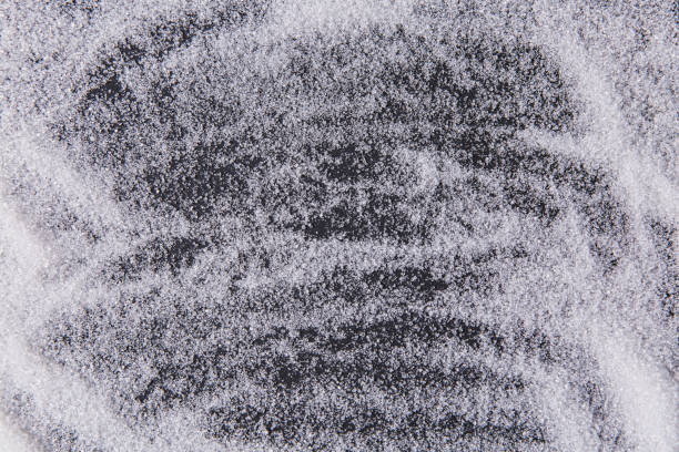 Texture of white sugar crystals on a black background