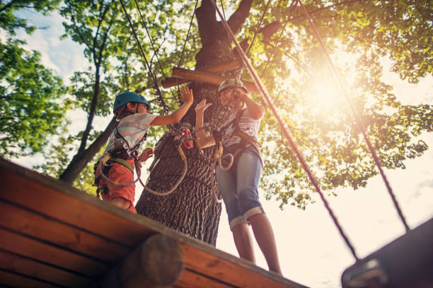 istock Brother and sister having fun during in ropes course  adventure park 863429416