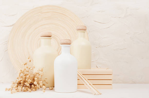 istock Blank white, beige cosmetics bottles with spikelets on white wood board, copy space, mock up. 863431522