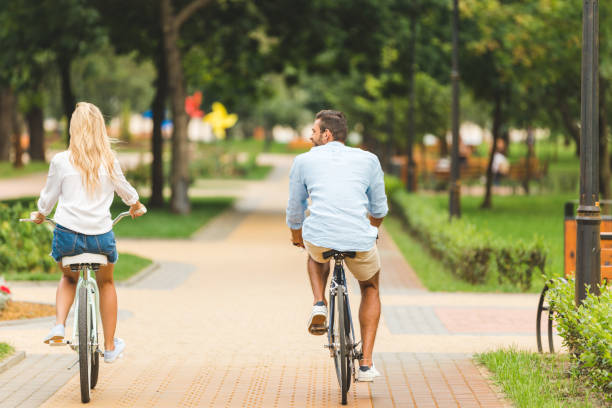 istock couple riding bicycles in park 863441504