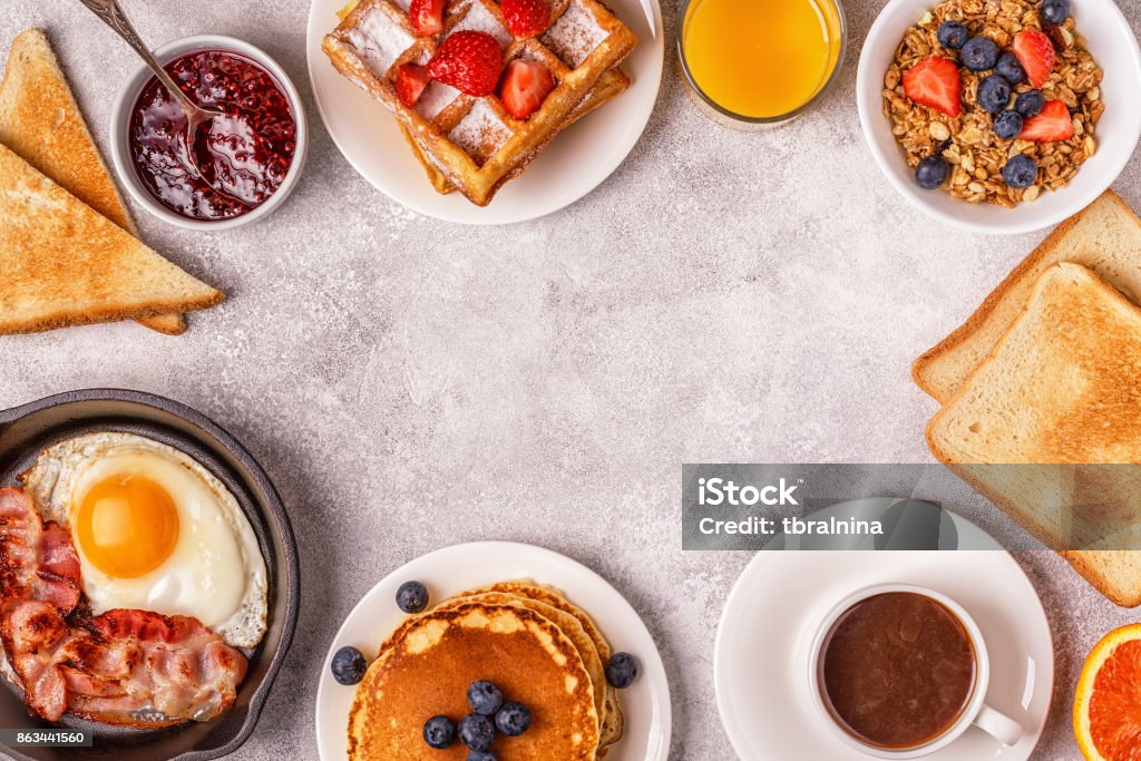 Delicious breakfast on a light table. Delicious breakfast on a light table. Top view, copy space. Breakfast Stock Photo