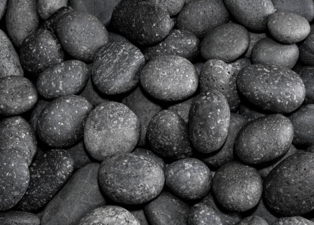 istock Texture of dried round gray river stone background 863441876