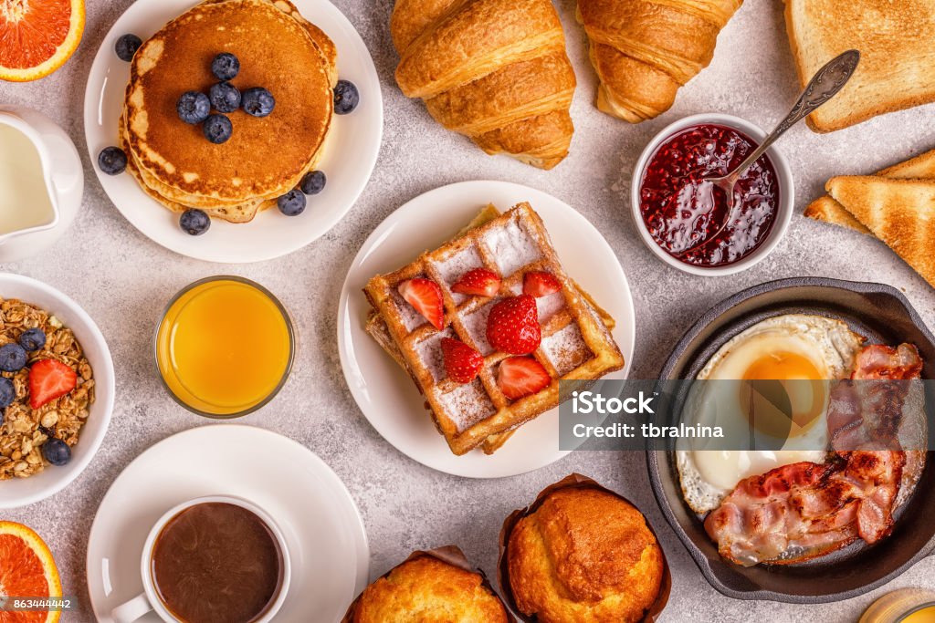 Delicious breakfast on a light table. Delicious breakfast on a light table. Top view, copy space. Brunch Stock Photo