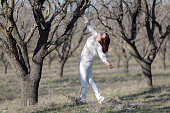 Young woman in a neglected almond orchard