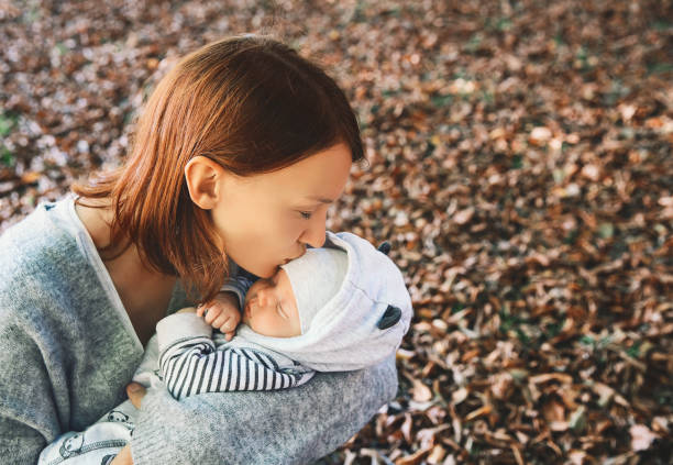 portrait of mother and baby. sleeping newborn baby in the hands of his mother. - winter women zen like photography imagens e fotografias de stock