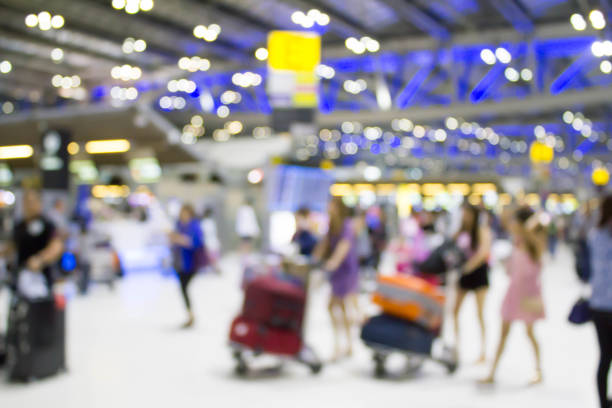 istock blurred people with baggage walking at the airport 863466366