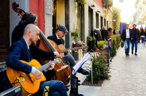 Street band playing music and tourists walking in the center of Alba (Piedmont, Italy) stock photo