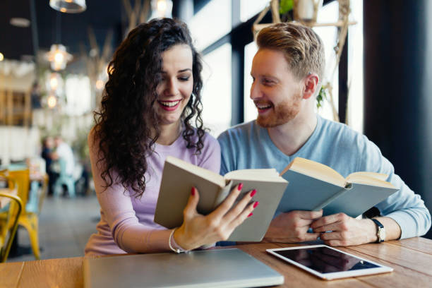 istock Young students spending time in coffee shop reading books 863473464