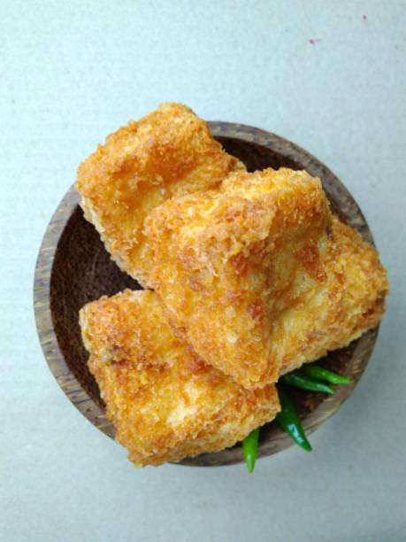 istock Flat Lays or top view, tahu sumedang (Fried Tofu) from west java,  indonesia with green hot chili at Wooden small bowl 863476790
