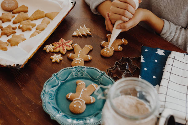 Christmas cookies decoration Women decorating gingerbread cookies, Christmas is near and she  prepare for holidays. gingerbread biscuit stock pictures, royalty-free photos & images