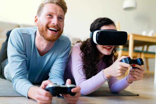 istock Happy young couple playing video games with virtual reality headsets 863482082
