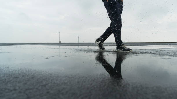 istock young male athlete stepping in puddle 863482388