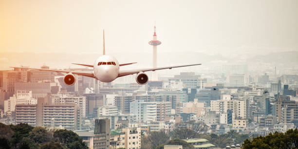 istock Airplane frying over the kyoto tower background 863485396