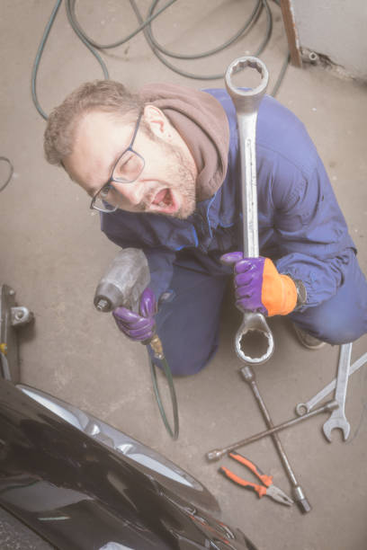 istock Car mechanic changing tire in the service - shop. 863486084