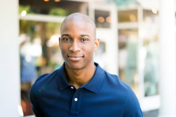 istock Smiling man standing with arms crossed in city 863489166