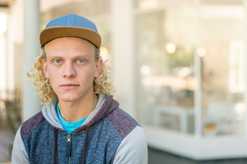 Portrait Man With Curly Blond Hair Wearing Baseball Photo - Download Image Now - iStock