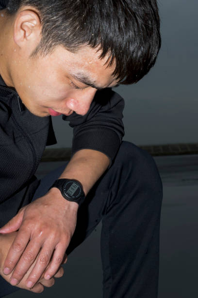 istock young asian athlete resting with sweat pouring after exercising 863492098
