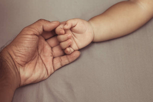 istock hands of children and parents. 863492114