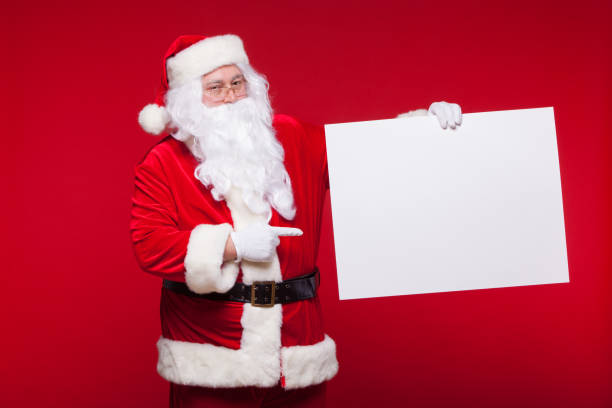 istock Santa Claus pointing in blank advertisement banner isolated on red background with copy space 863492248