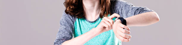 istock Running out of time: fingers tap watch in cropped view 863492632